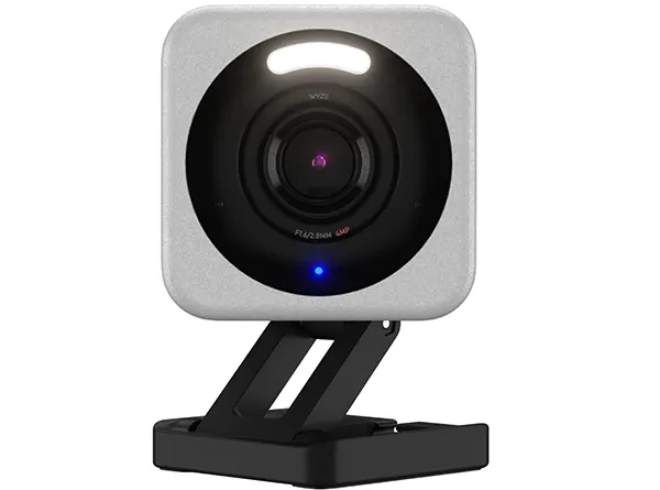WYZE Cam v4 2.5K indoor security camera in white on a desk